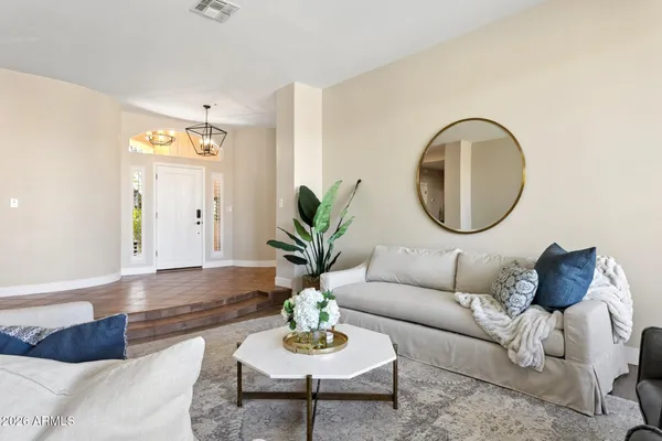 a kitchen with stainless steel appliances a refrigerator a sink dishwasher a stove and white cabinets with wooden floor