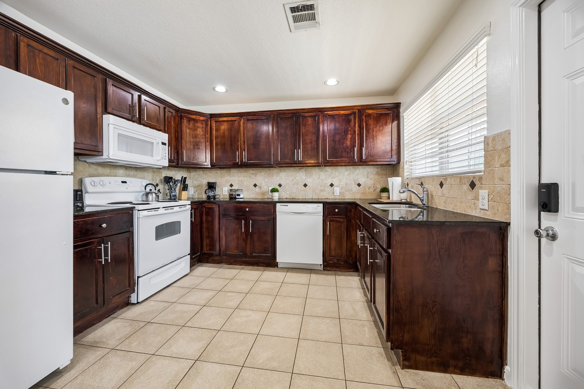 3237 Rosedale Street, Unit 4 Houston, TX 77004 - Photo 7 of 17 a kitchen with stainless steel appliances granite countertop a stove sink and cabinets