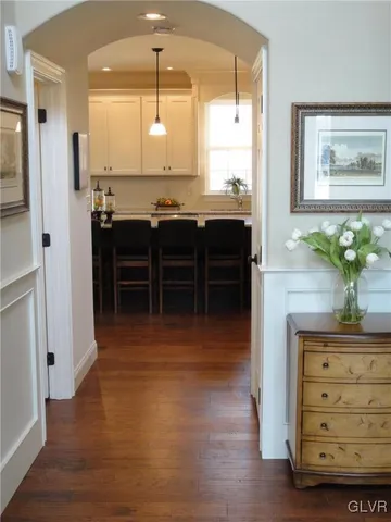 a kitchen with kitchen island a counter top space a sink stainless steel appliances and cabinets