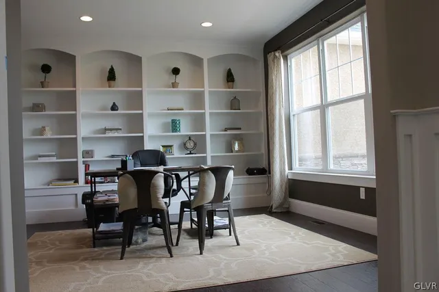 a view of a workspace with furniture and a window