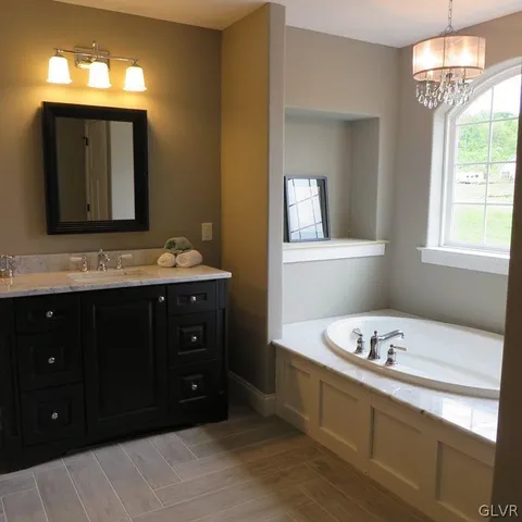 a bathroom with a sink vanity and mirror