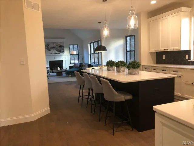 a large kitchen with a table and chairs
