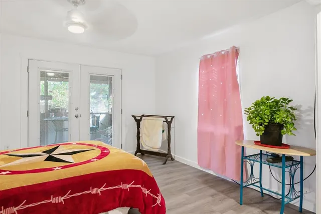 a bedroom with a bed and a potted plant