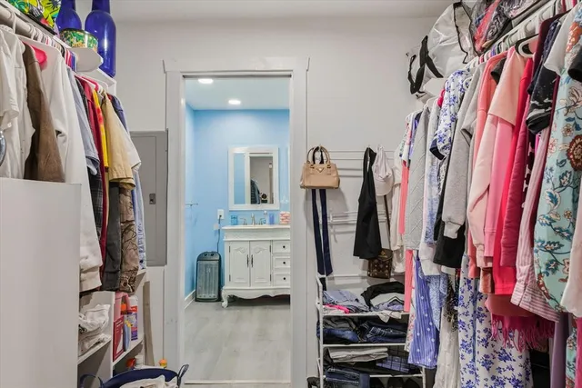 a view of walk in closet with clothes