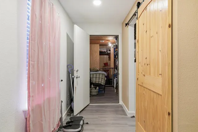 a view of a hallway with wooden floor and staircase