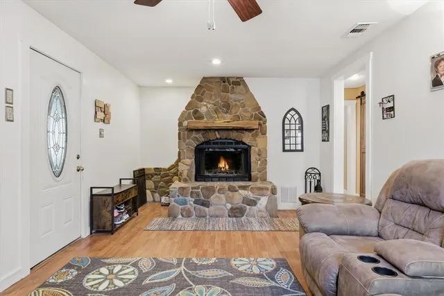 a living room with furniture and a fireplace