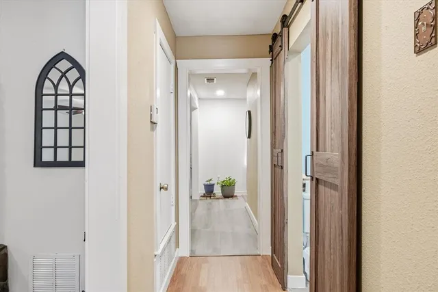 a view of a hallway view with wooden floor and staircase