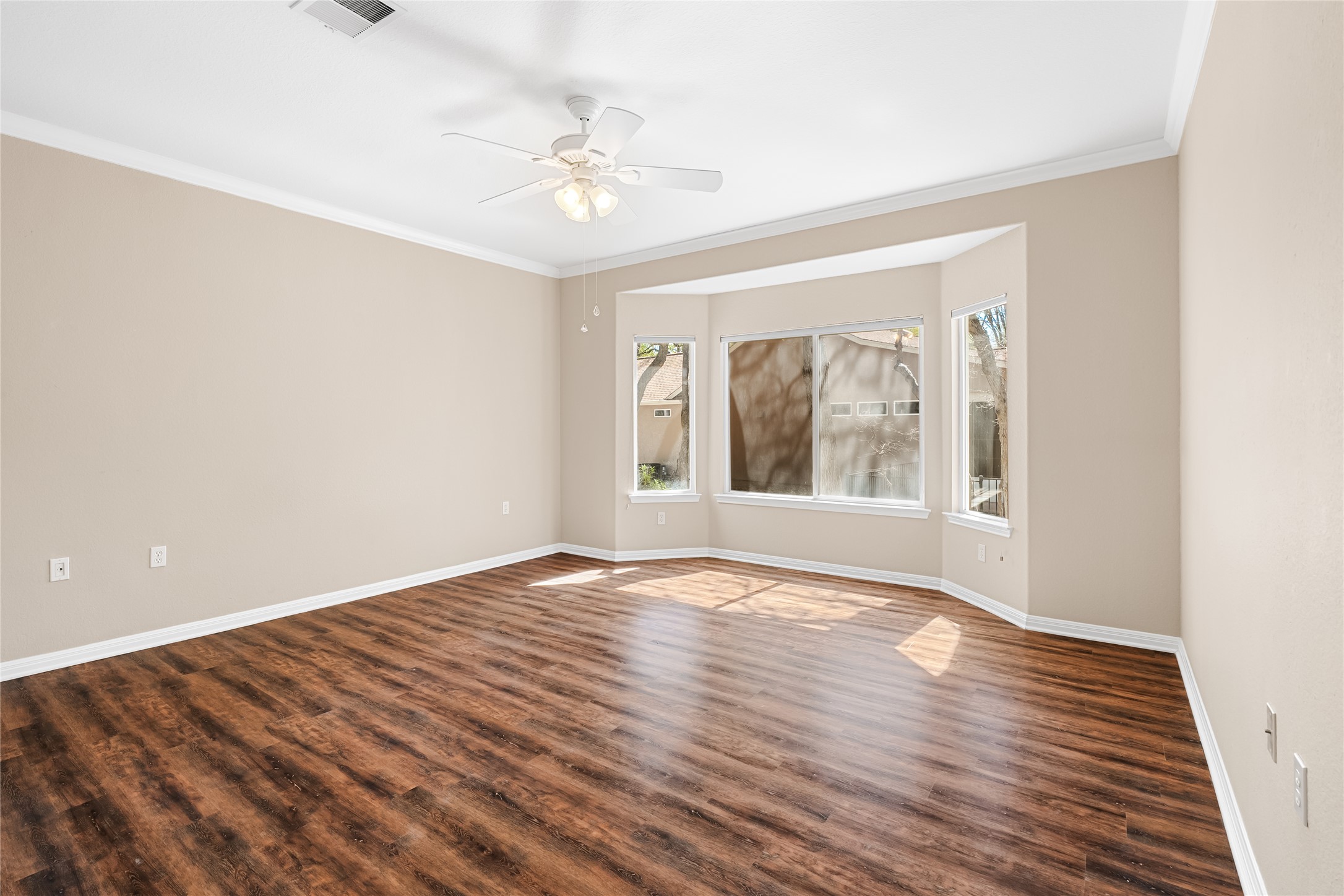 103 Harness Lane Georgetown, TX 78633 - Photo 18 of 38 a view of an empty room with wooden floor and a window