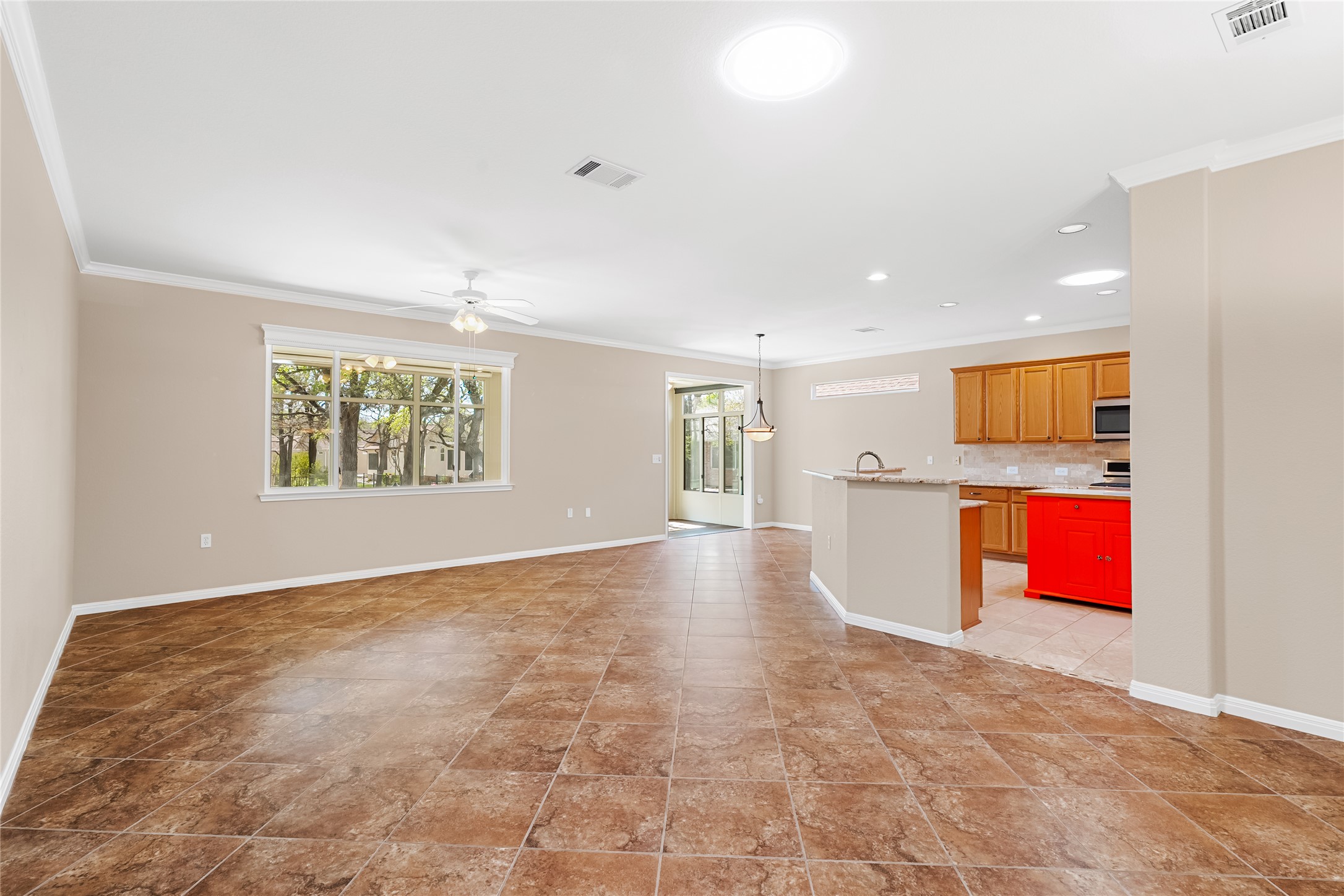103 Harness Lane Georgetown, TX 78633 - Photo 9 of 38 an empty room with kitchen view and windows