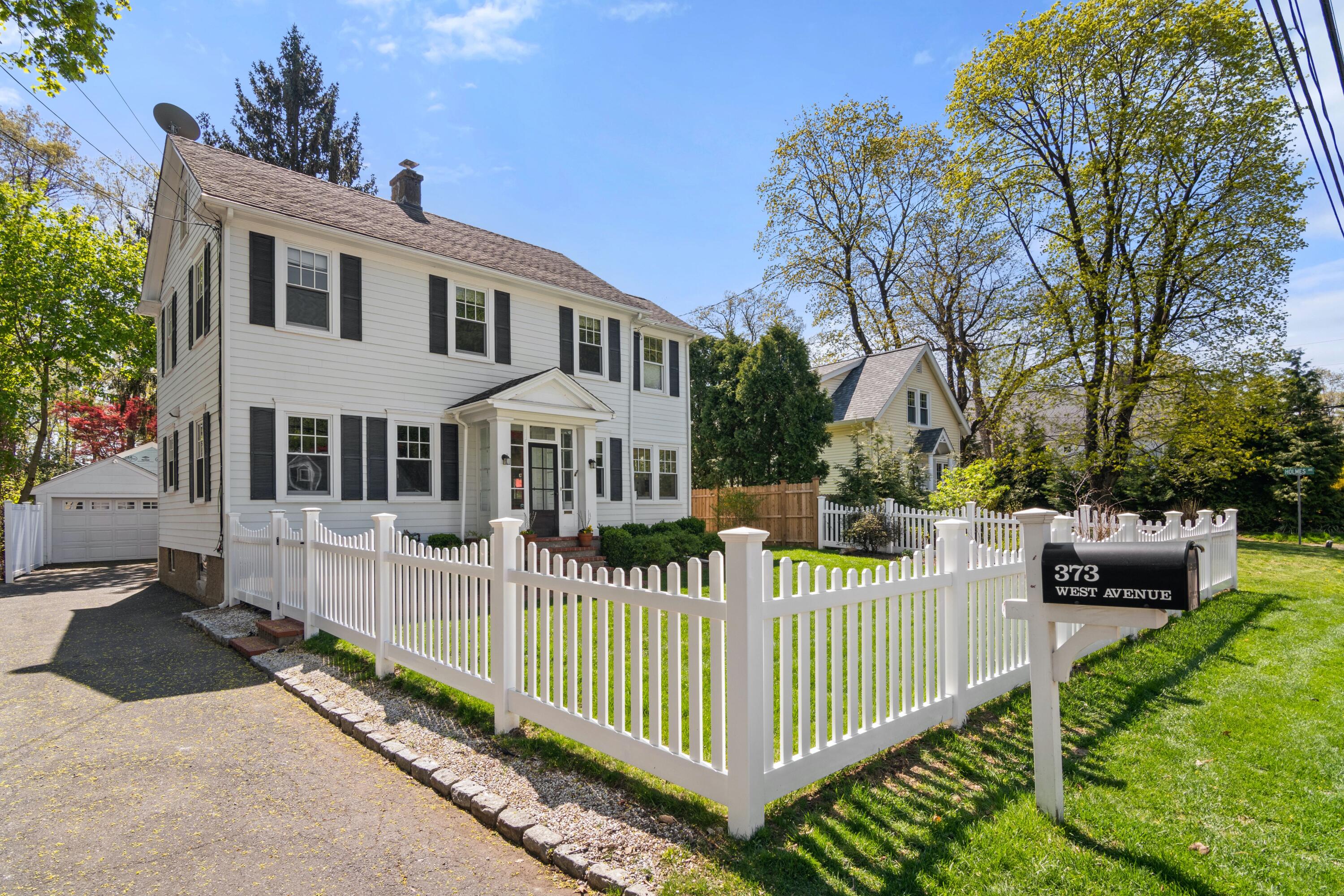 a view of a house with wooden fence