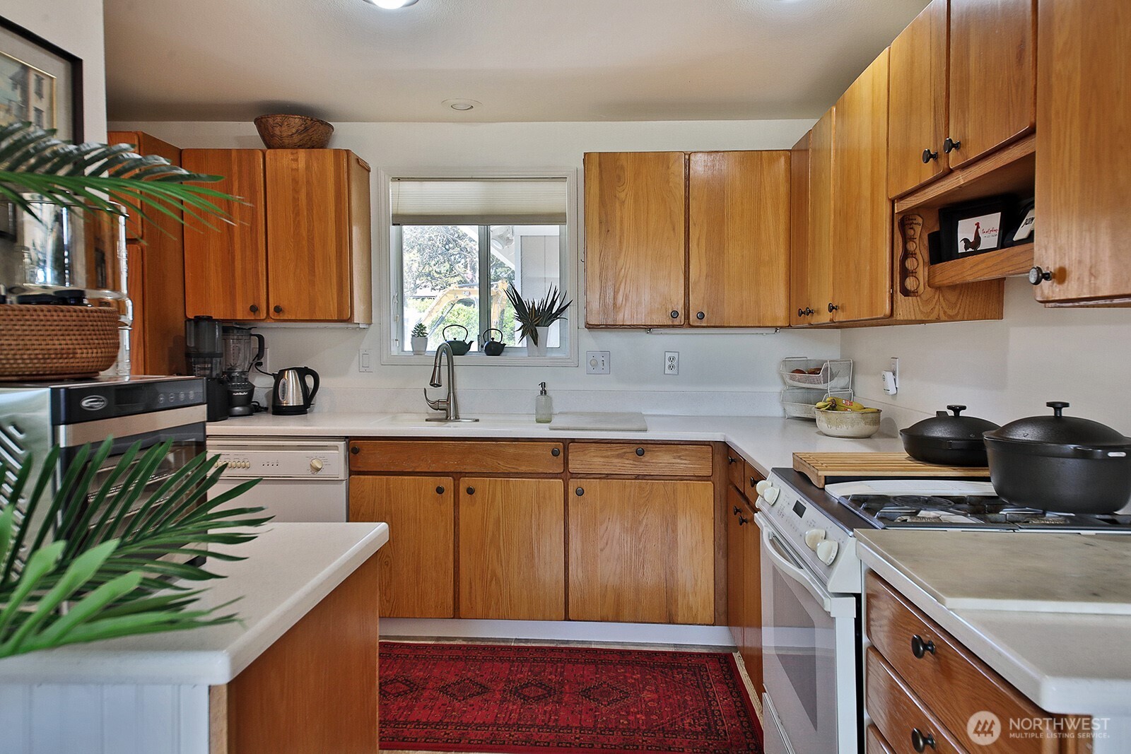 424 Island View Lane Langley, WA 98260 - Photo 18 of 39 a kitchen with a sink stove and cabinets