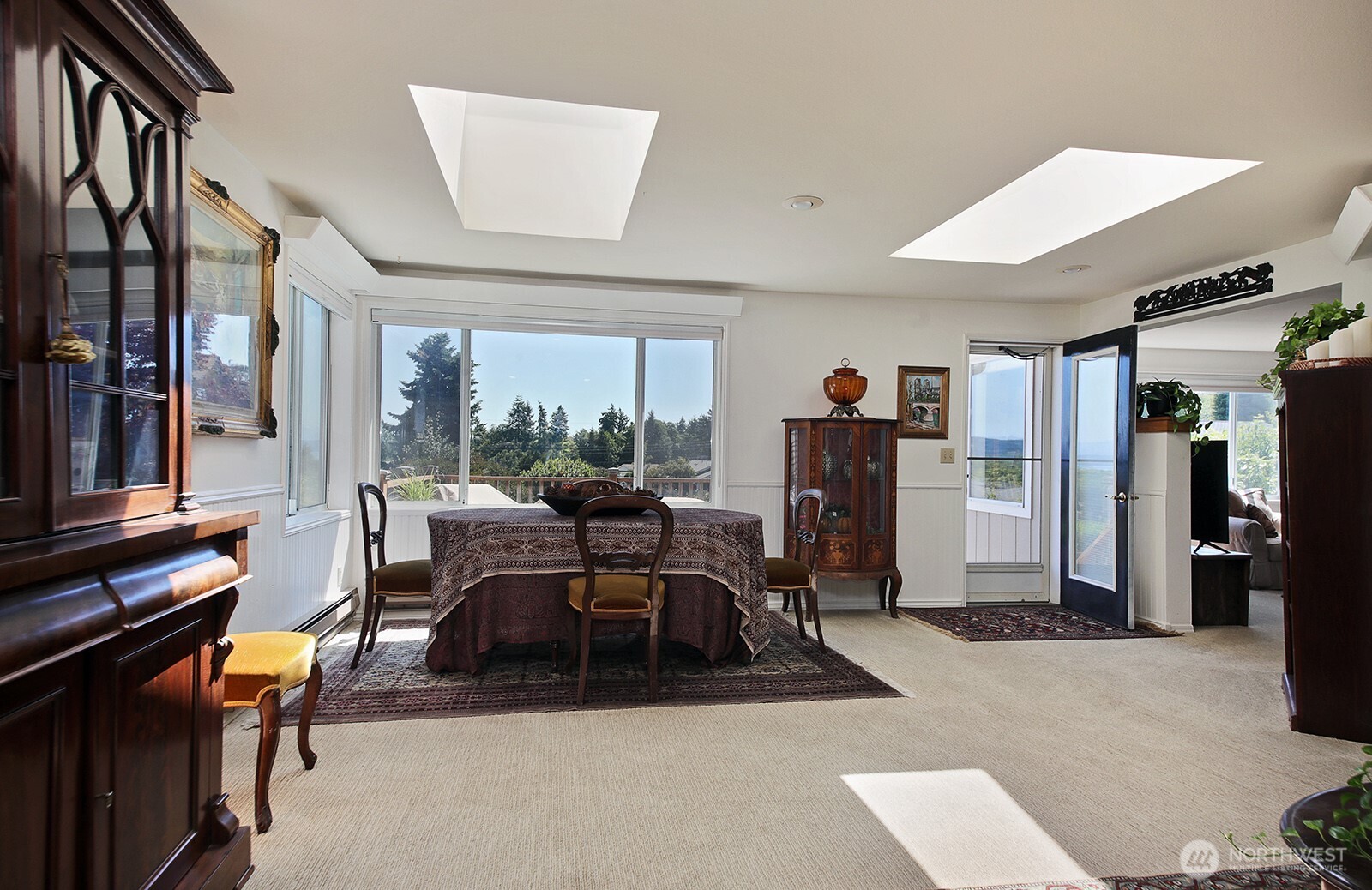 424 Island View Lane Langley, WA 98260 - Photo 10 of 39 a living room with furniture a flat screen tv and a large window