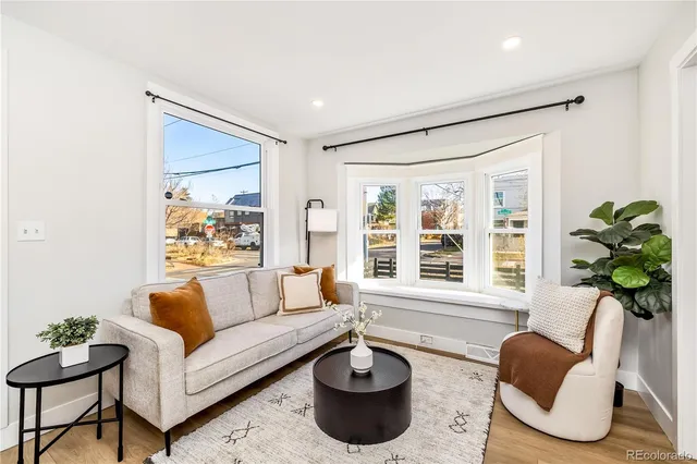 a living room with furniture potted plant and a window