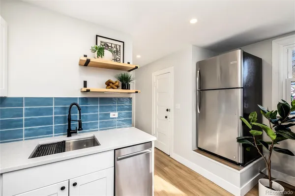 a kitchen with a refrigerator and a sink