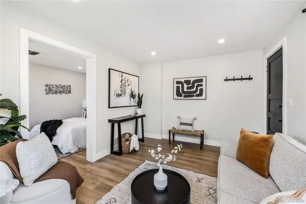 a living room with furniture and a wooden floor