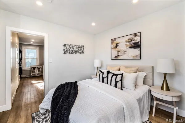 a bedroom with a bed and a painting on the wall