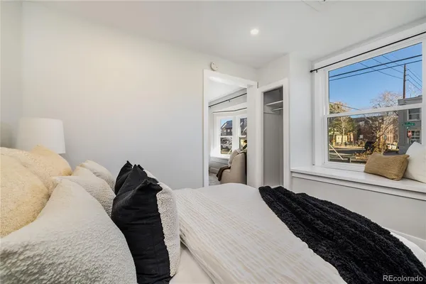 a bed room with a bed and a large mirror