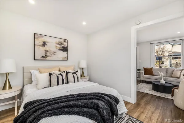 a bedroom with a bed and wooden floor
