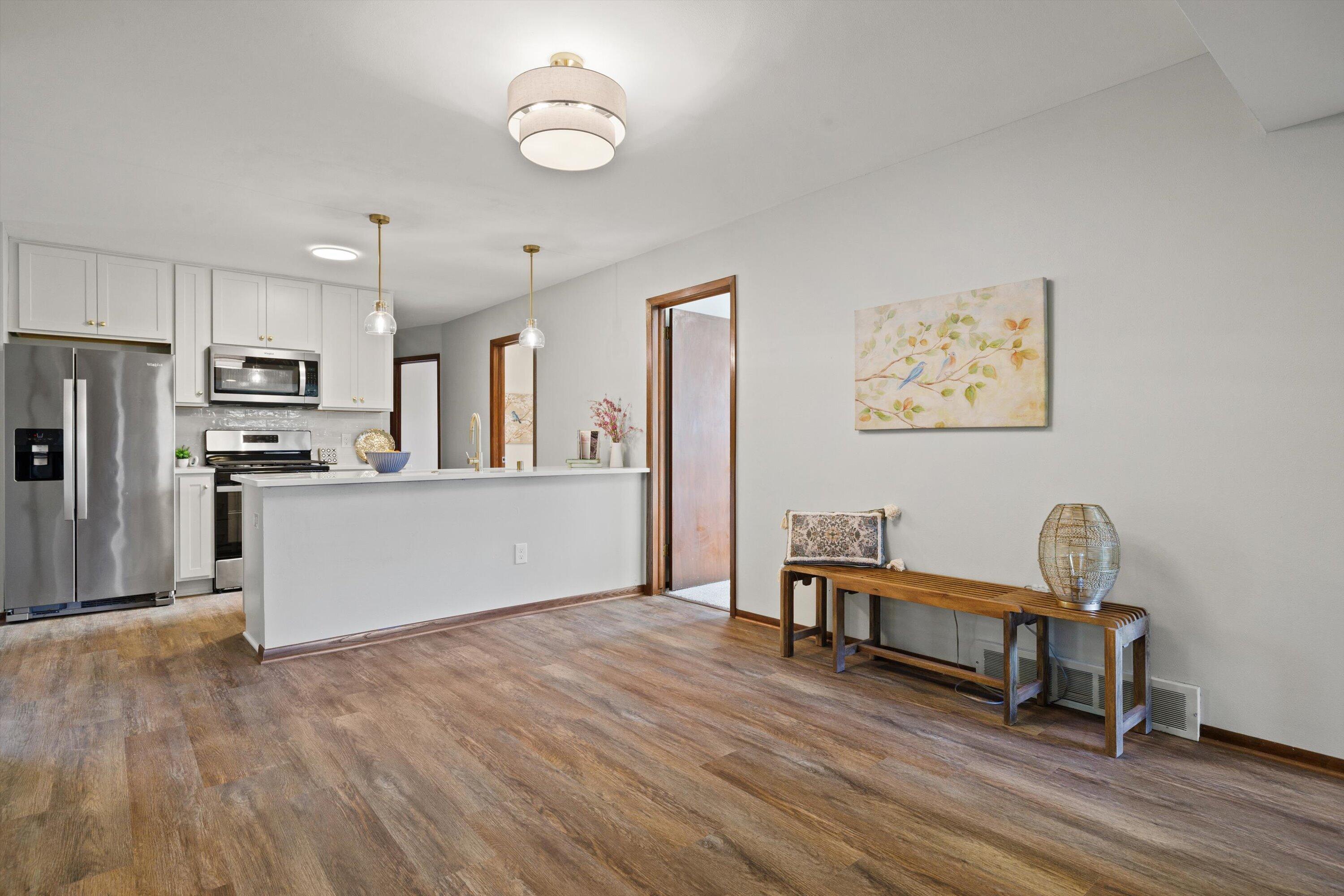 726 Royal Park Road Caledonia, WI 53402 - Photo 20 of 29 Open walkway seamlessly connects the living room to the kitchen and dining areas, enhancing the home’s natural flow