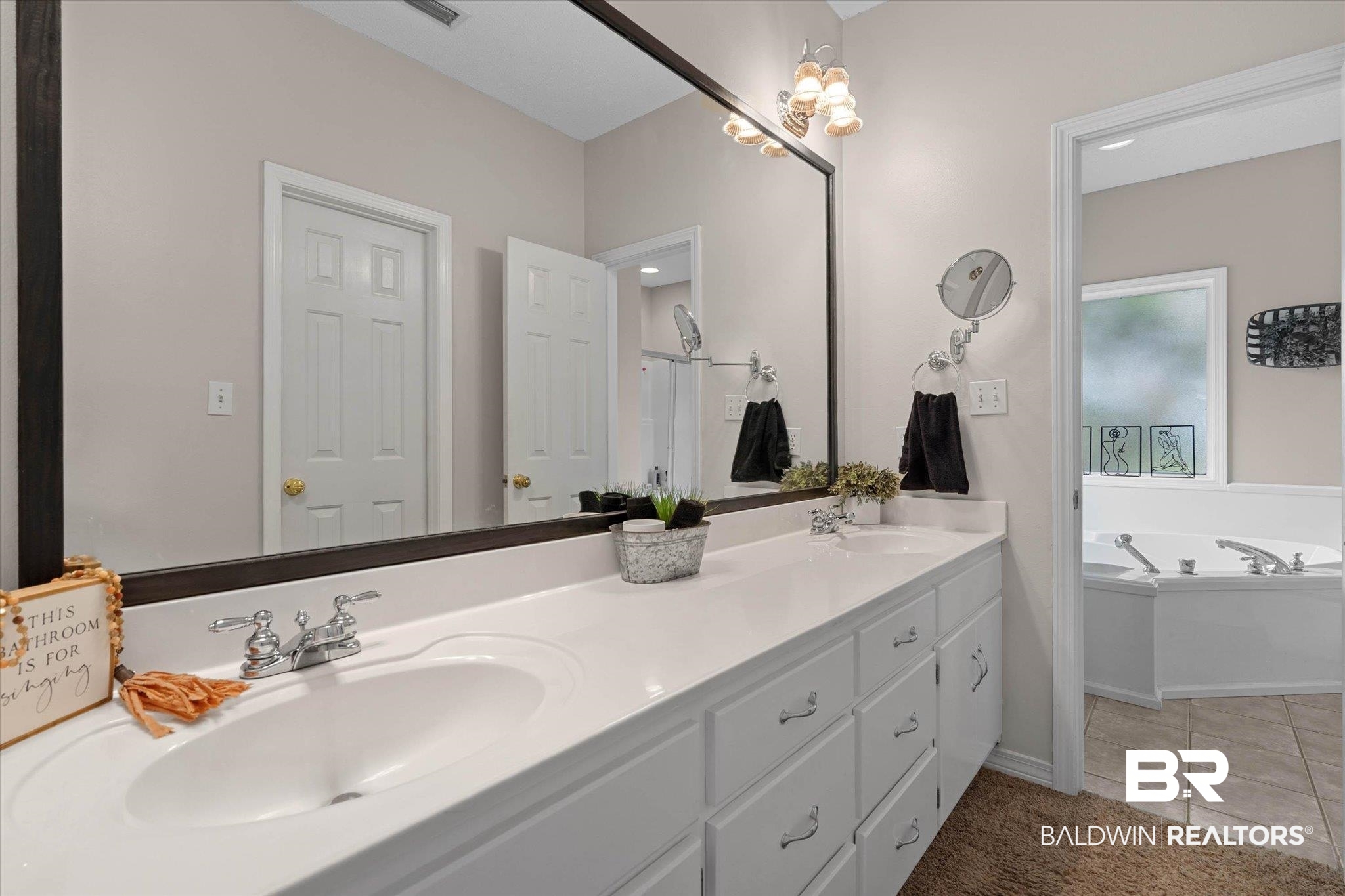 3170 Scott Dairy Loop Road West Mobile, AL 36695 - Photo 13 of 24 Dual vanity with undermount sinks and chrome fixtures, ample white cabinetry, and a large framed mirror with overhead lighting