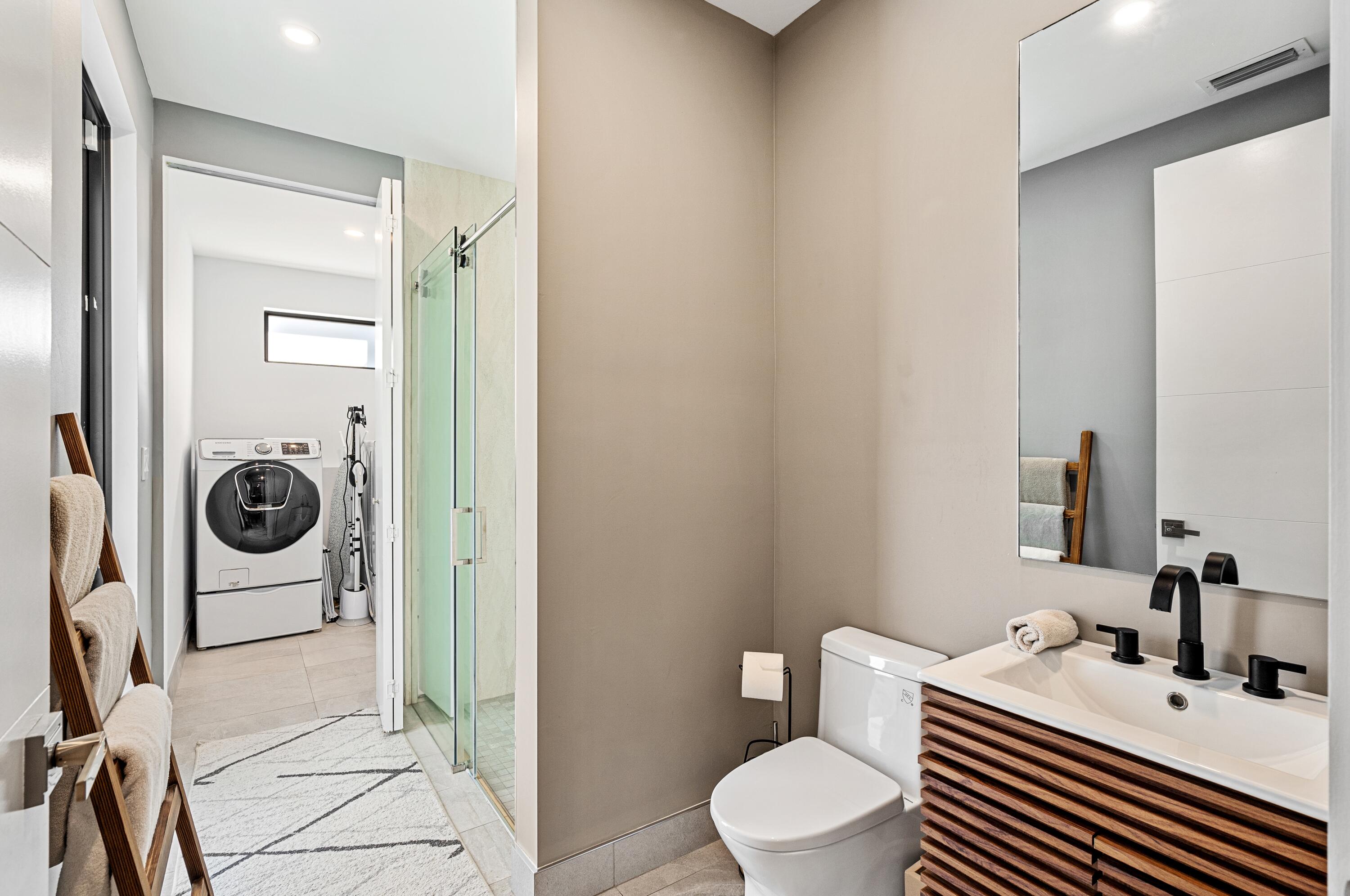 709 Northwest 6th Drive Boca Raton, FL 33486 - Photo 13 of 45 a bathroom with a sink a toilet and a mirror