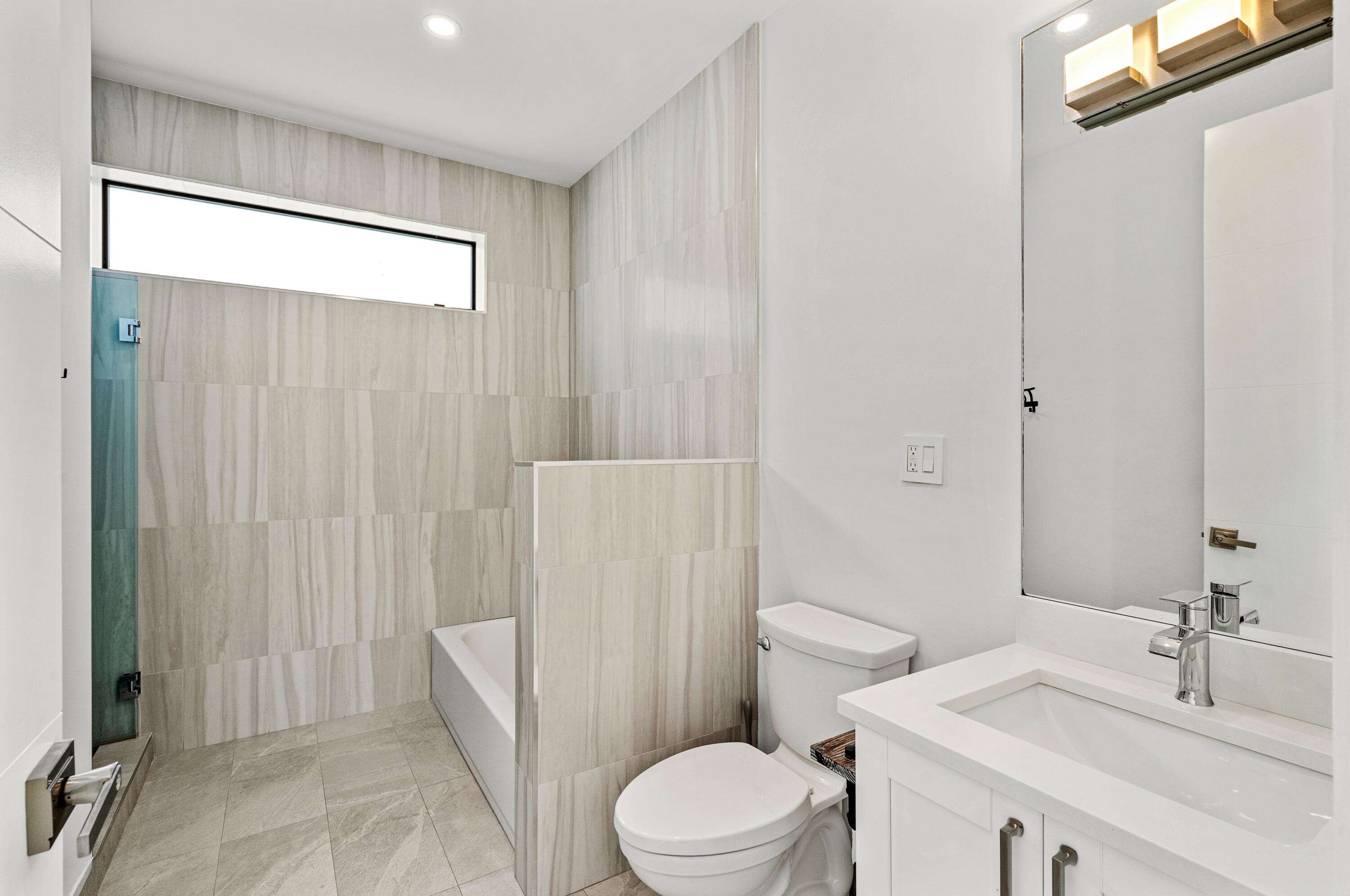 709 Northwest 6th Drive Boca Raton, FL 33486 - Photo 26 of 45 a bathroom with a sink a toilet and shower