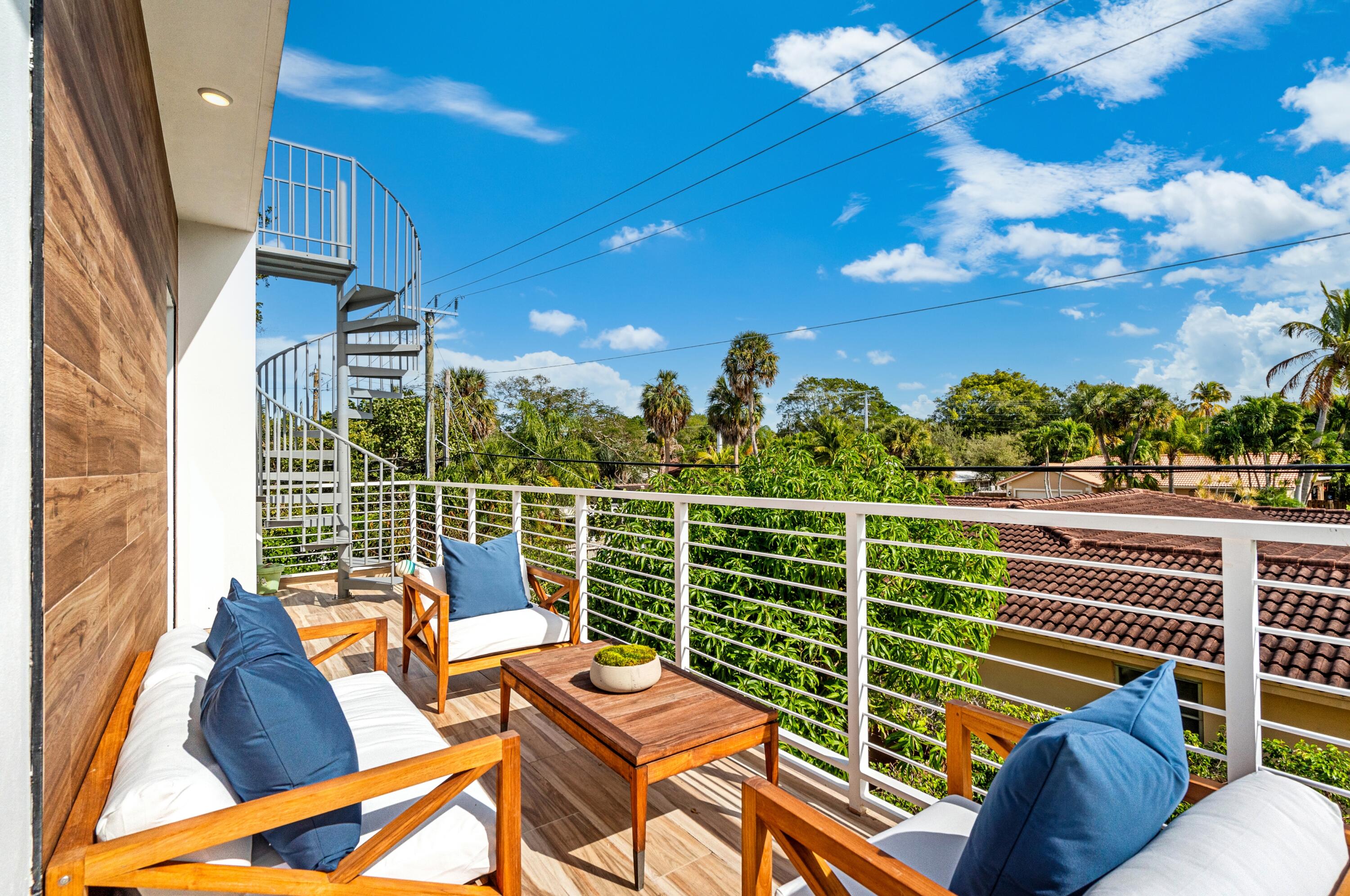 709 Northwest 6th Drive Boca Raton, FL 33486 - Photo 28 of 45 a view of a balcony with couches and wooden floor