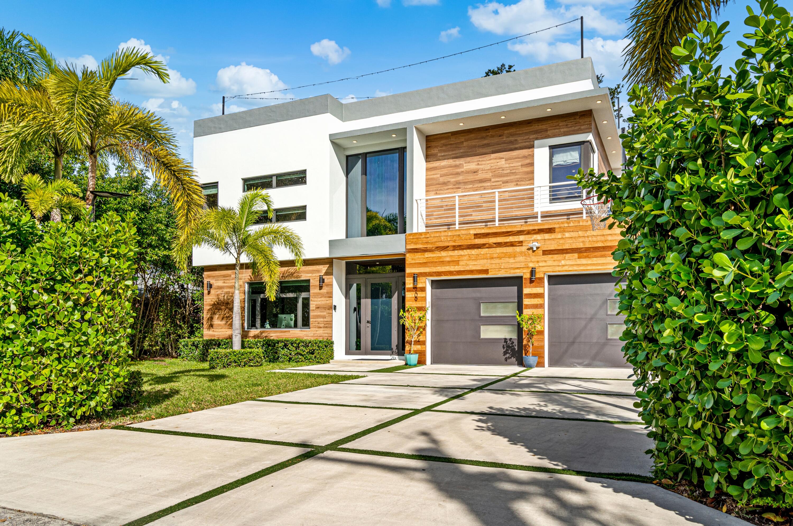 709 Northwest 6th Drive Boca Raton, FL 33486 - Photo 3 of 45 a front view of a brick house with a yard