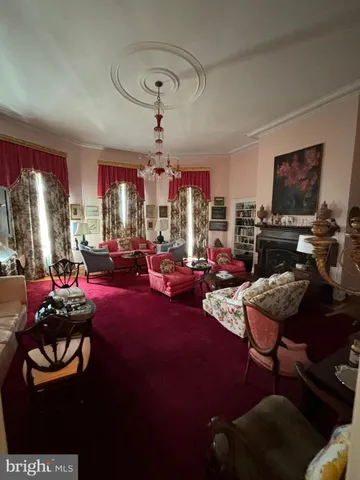 a kitchen with granite countertop a stove a sink dishwasher a dining table and chairs with wooden cabinets