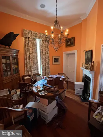 a bedroom with bed and wooden floor