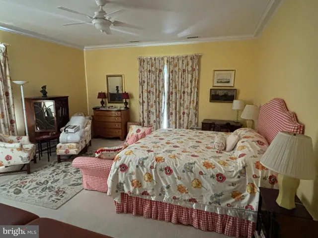 a work room with furniture a rug and a large window