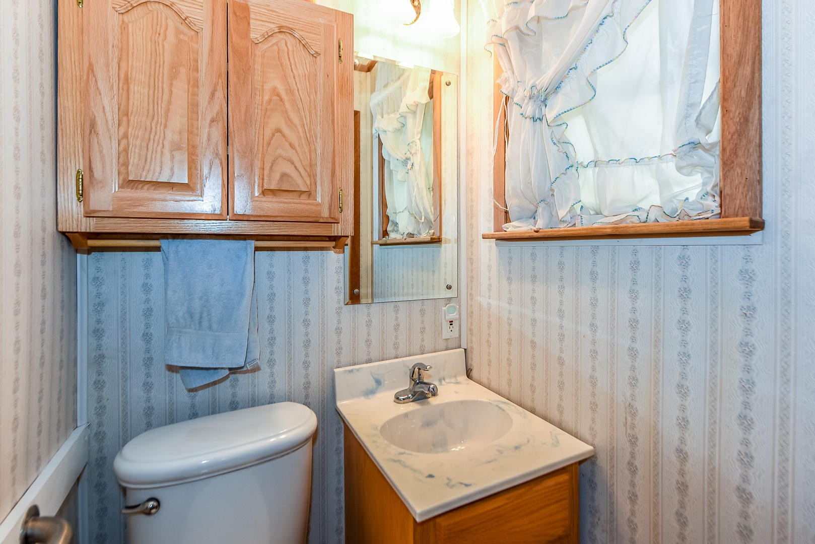 104 East Price Road Oak Ridge, TN 37830 - Photo 12 of 16 a bathroom with a sink a toilet and a mirror