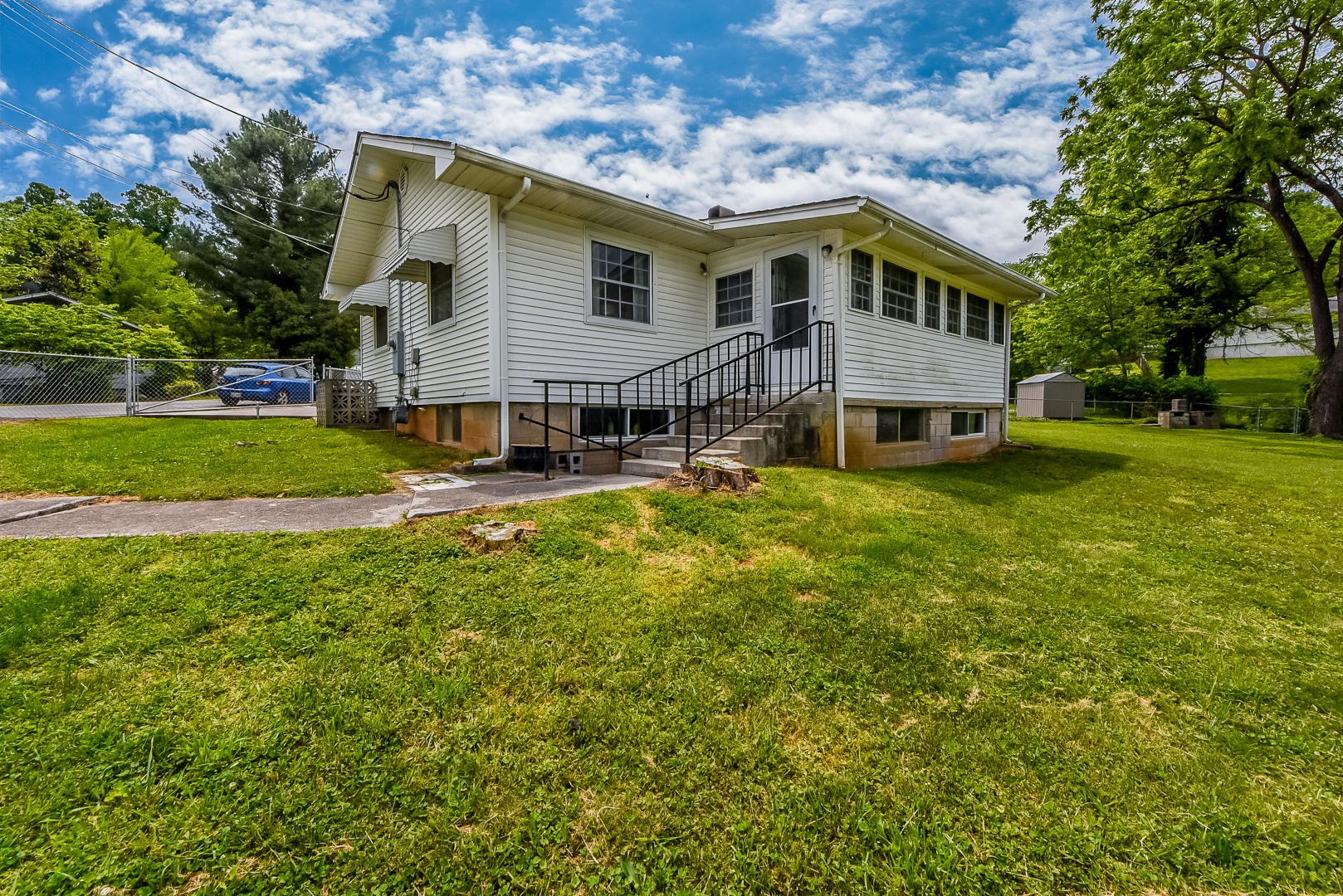 104 East Price Road Oak Ridge, TN 37830 - Photo 16 of 16 a view of a house with a big yard and large trees