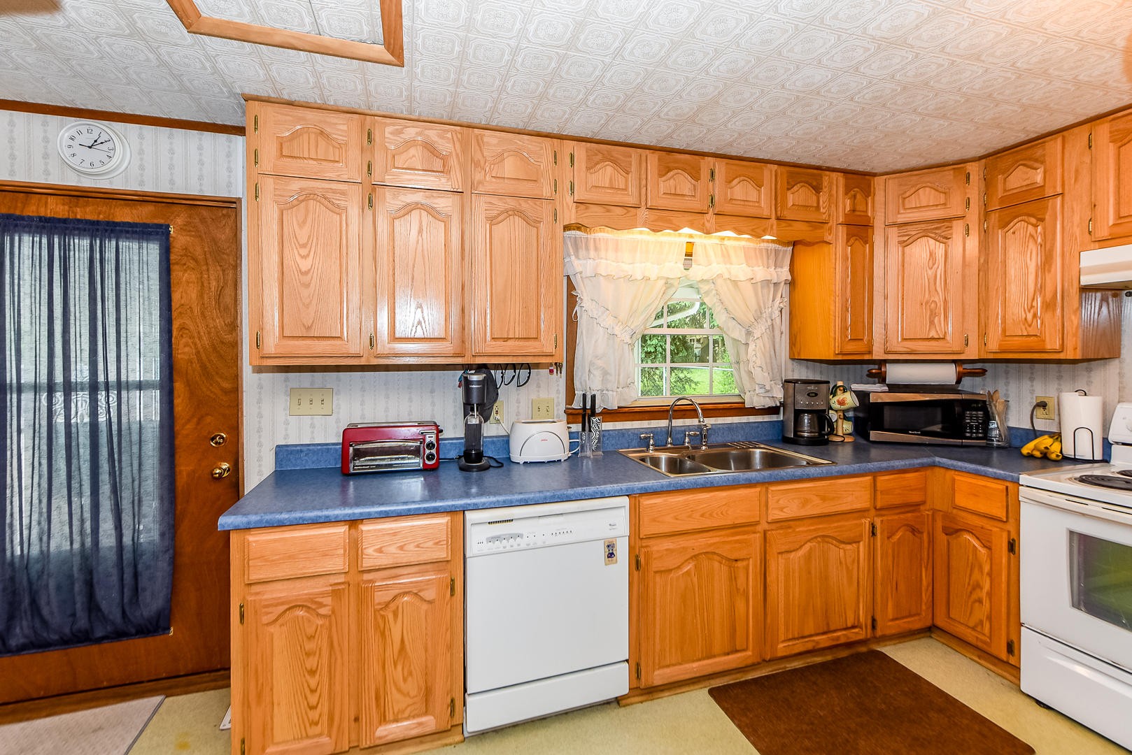 104 East Price Road Oak Ridge, TN 37830 - Photo 6 of 16 a kitchen with stainless steel appliances granite countertop a stove a sink and a microwave