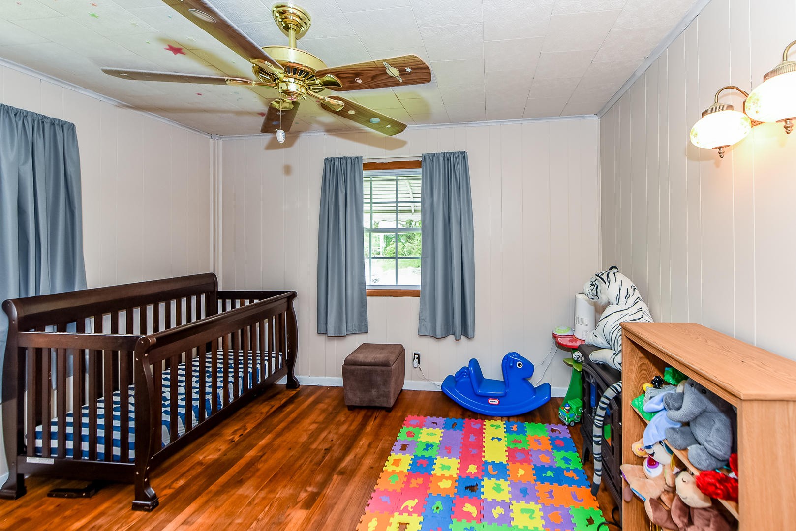 104 East Price Road Oak Ridge, TN 37830 - Photo 9 of 16 a bedroom with baby crib and a window