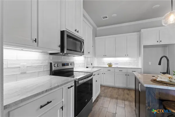 a view of a livingroom with a ceiling fan and window