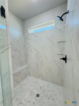 a spacious bathroom with a double vanity sink toilet and mirror