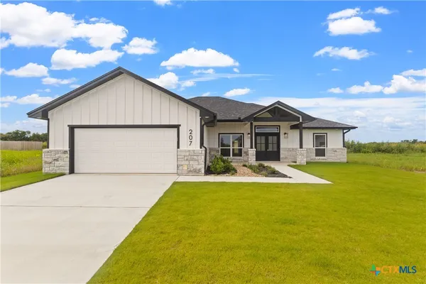 a view of a house with swimming pool and a yard
