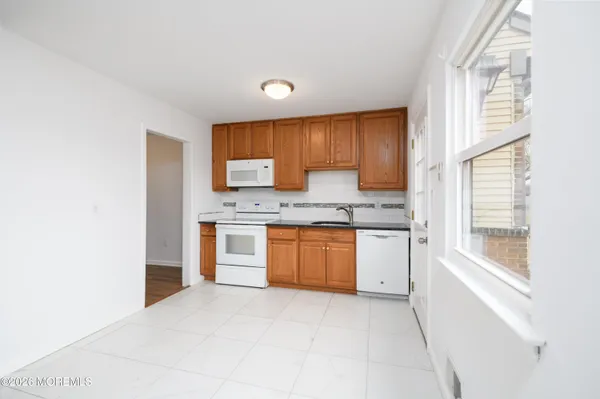 a kitchen with a refrigerator and a stove top oven