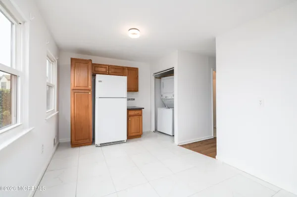 a view of a kitchen with a refrigerator cabinets and a window