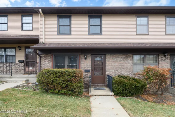 a view of brick house with large windows