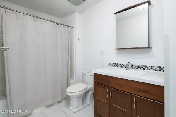 a bathroom with a sink a toilet and mirror