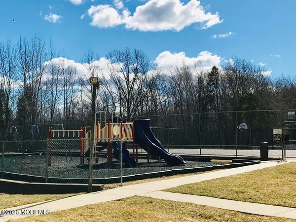 a view of a swimming pool with a bench in front of house
