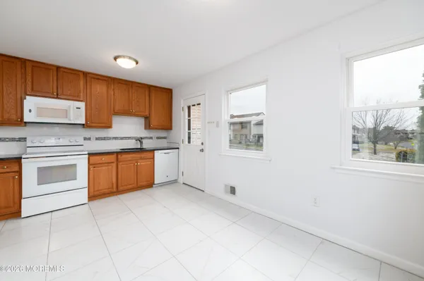 a kitchen with a stove a sink and a window