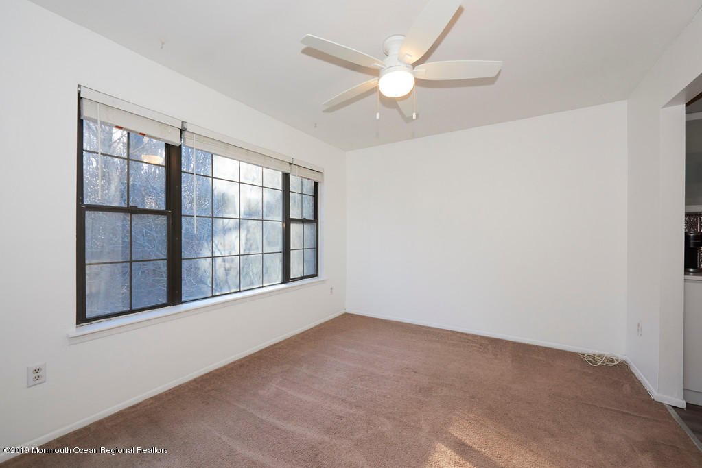 200 Portland Road, Unit E18 Highlands, NJ 07732 - Photo 5 of 16 an empty room with windows and fan