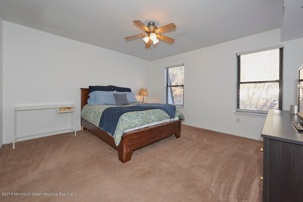 200 Portland Road, Unit E18 Highlands, NJ 07732 - Photo 10 of 16 a bedroom with a bed and window