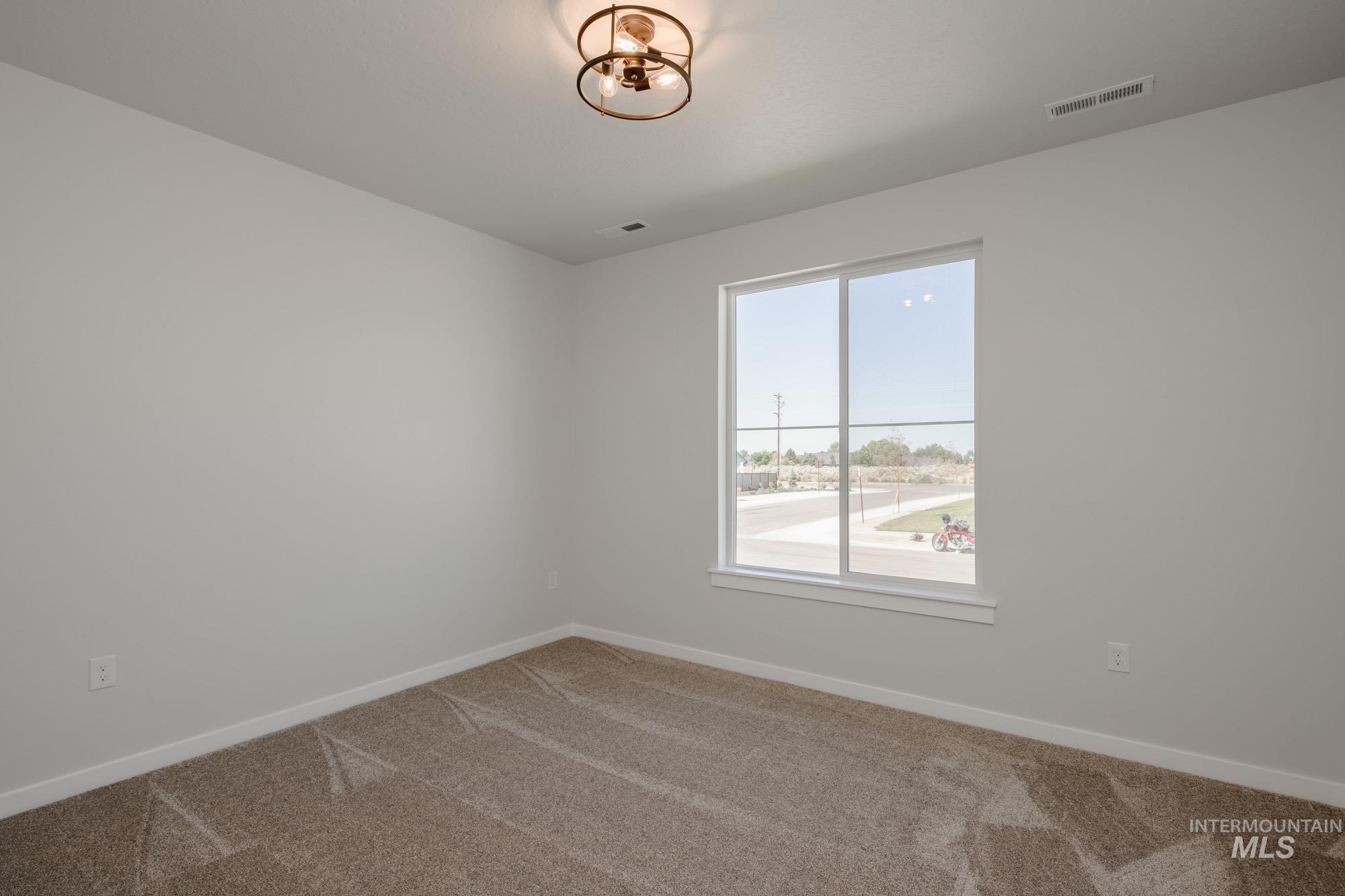 2231 South Border Way Meridian, ID 83642 - Photo 13 of 23 Empty room with carpet floors and baseboards