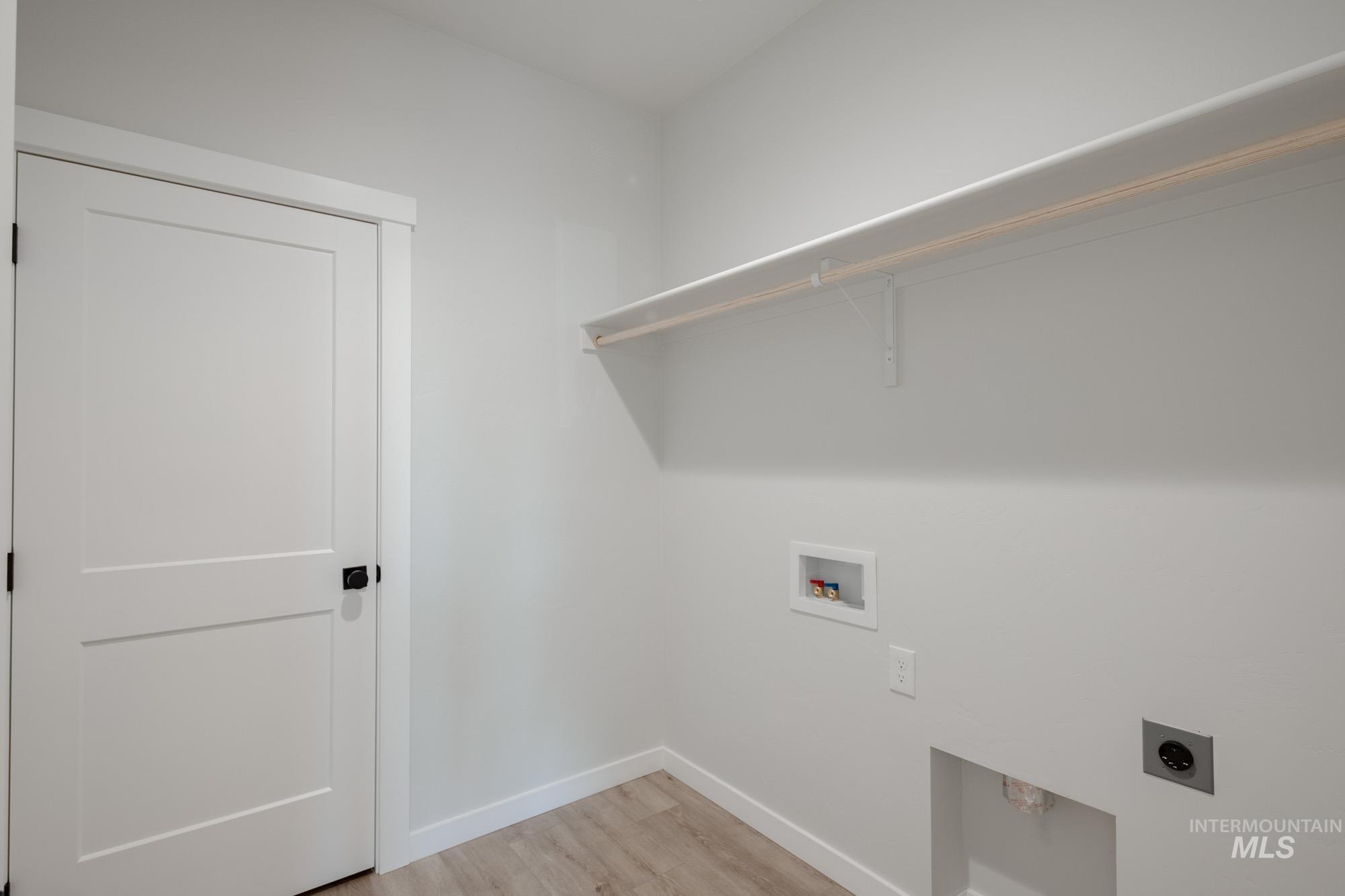 2231 South Border Way Meridian, ID 83642 - Photo 16 of 23 Laundry room with light wood-style floors, hookup for a washing machine, and electric dryer hookup
