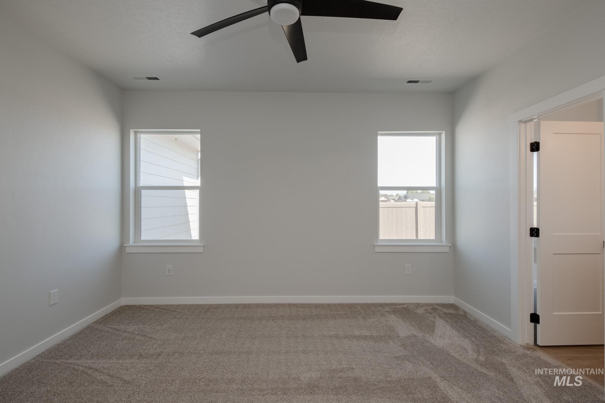 2231 South Border Way Meridian, ID 83642 - Photo 21 of 23 Unfurnished room featuring light colored carpet and a ceiling fan