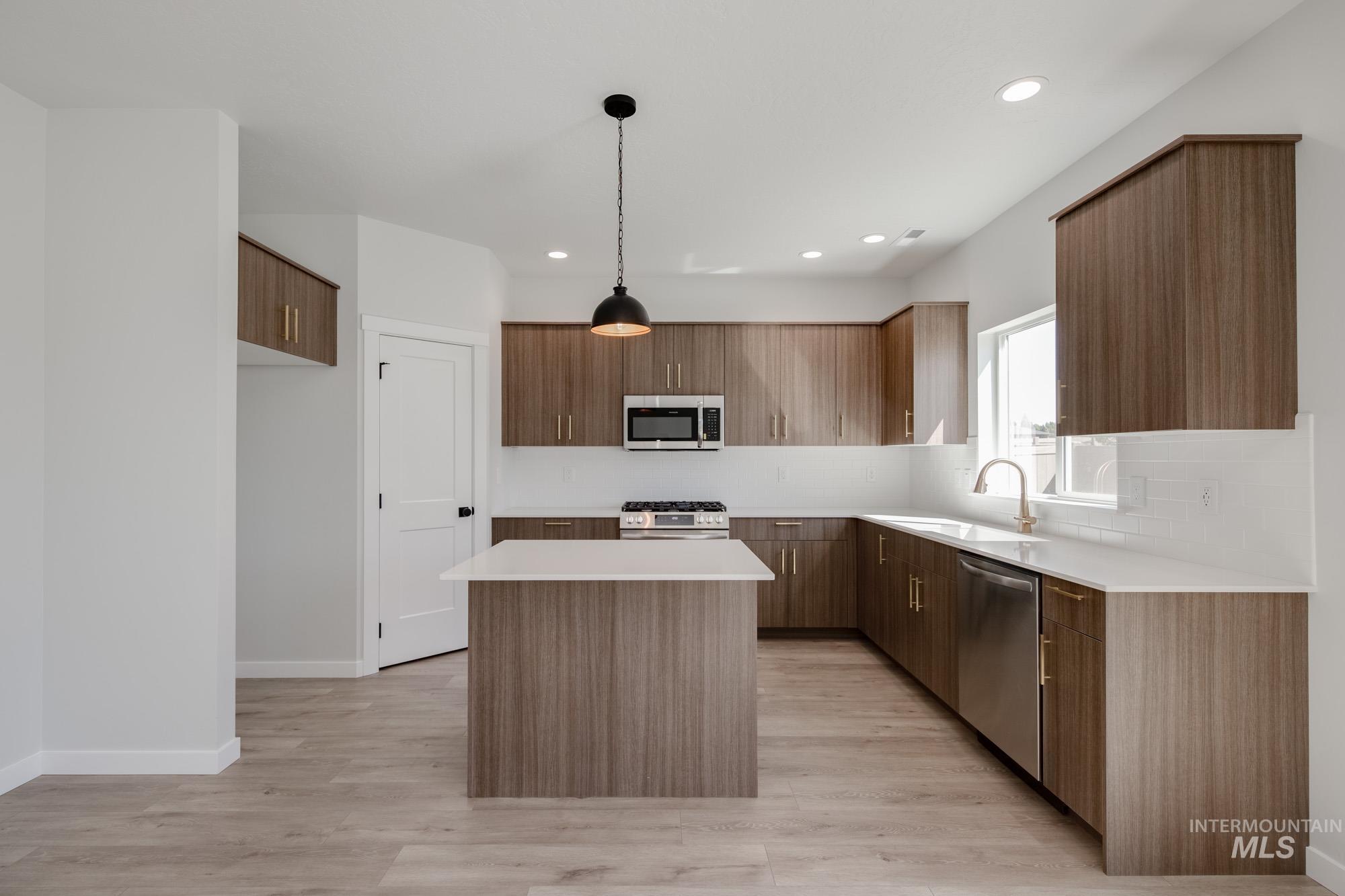2231 South Border Way Meridian, ID 83642 - Photo 3 of 23 Kitchen featuring modern cabinets, pendant lighting, a center island, and stainless steel appliances